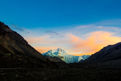 Scenic view of snowcapped mountains against sky during sunset