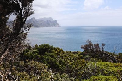 Scenic view of sea and mountains against sky