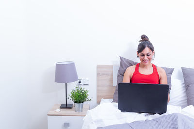 Young woman using laptop at home