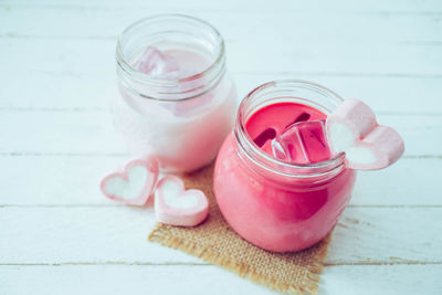 High angle view of pink flowers in jar on table