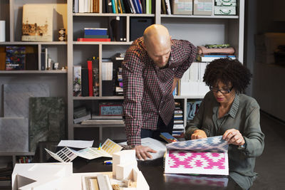 Business people choosing wallpaper in office