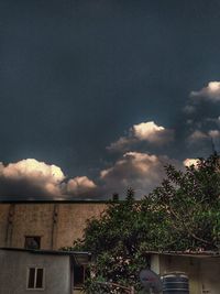 Low angle view of house against cloudy sky