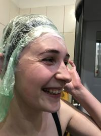 Close-up portrait of a young woman in bathroom