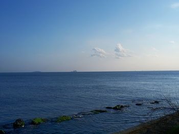 Scenic view of sea against blue sky