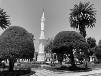 Panoramic view of palm trees and buildings against sky