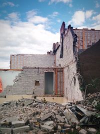 Abandoned house against cloudy sky