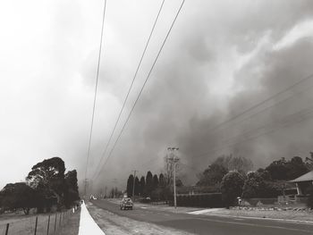 Panoramic view of cars on road against sky