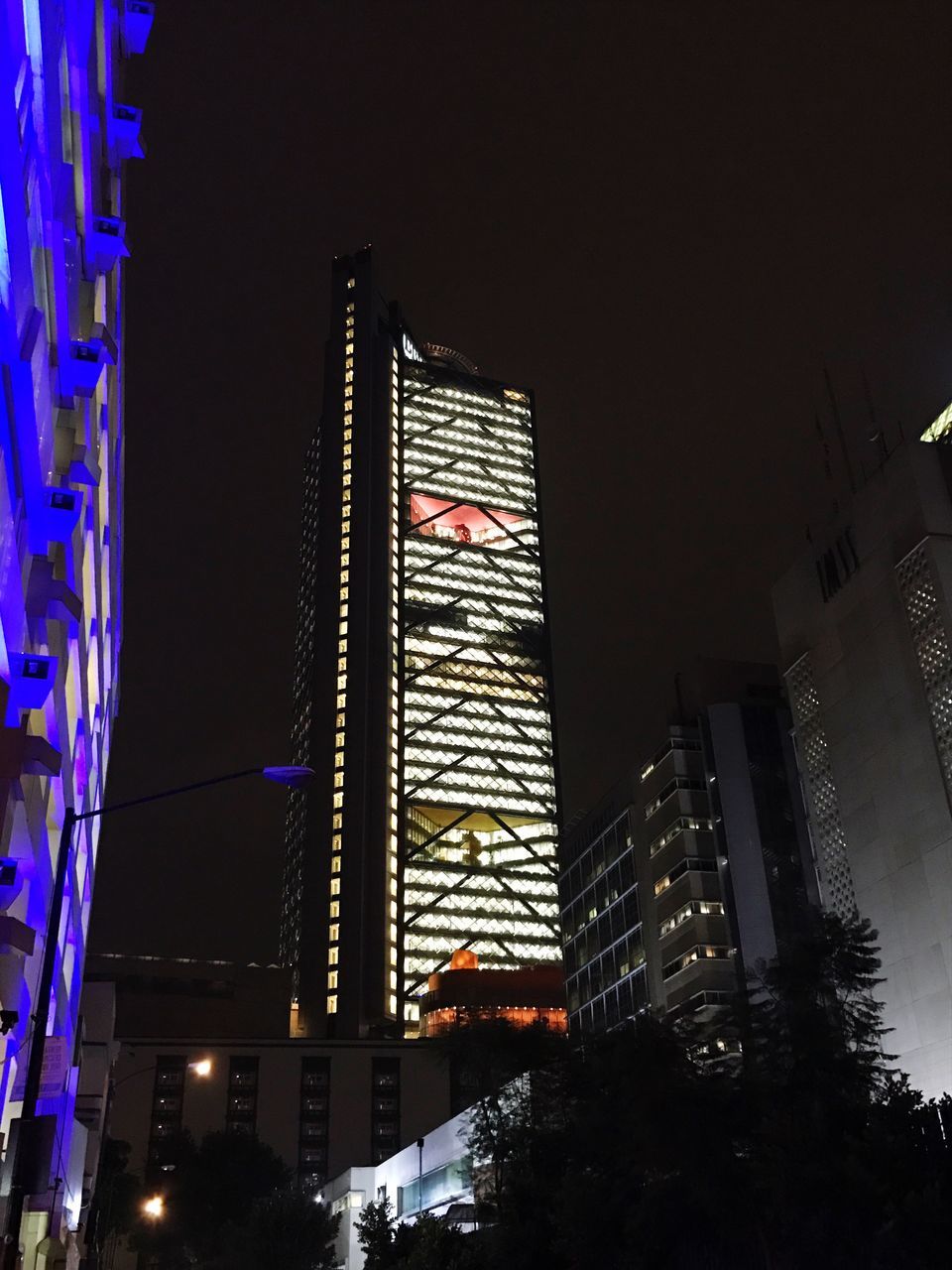 LOW ANGLE VIEW OF ILLUMINATED SKYSCRAPERS