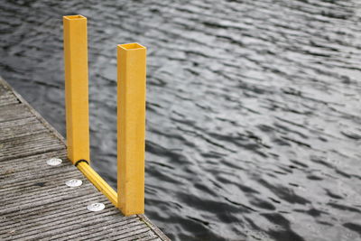 High angle view of yellow ladder on sea