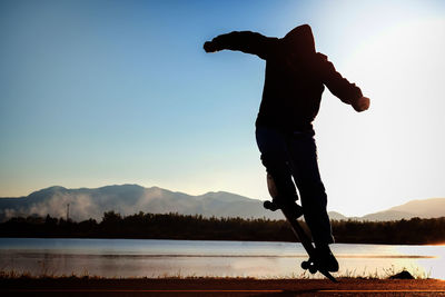 Low angle view of man standing on lake