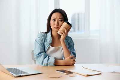 Businesswoman talking on phone at office