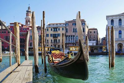 Boats in river with buildings in background