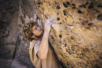 High angle view of hiker climbing rock formation