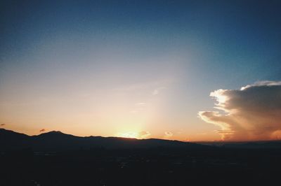 Silhouette landscape against sky during sunset