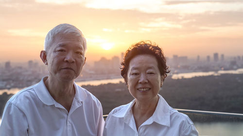 Portrait of smiling man against sky during sunset