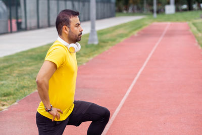 Young man exercising on road