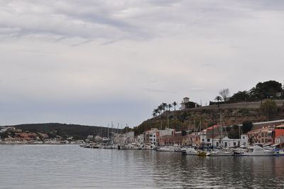 Town by sea against sky