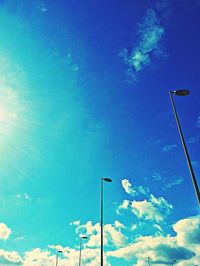 Low angle view of street light against blue sky