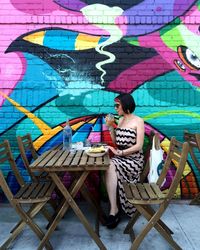 Full length of woman standing in graffiti