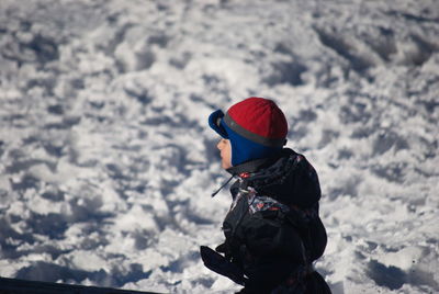 Rear view of girl in snowcapped mountains during winter