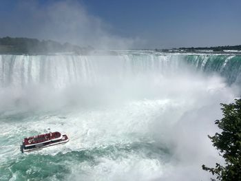 Scenic view of waterfall in sea