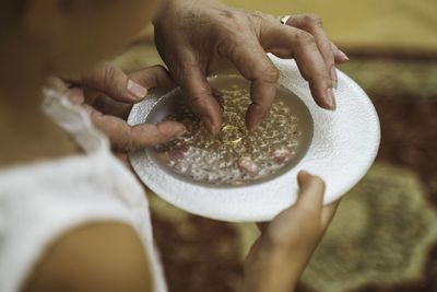 Close-up of hand holding wedding rings