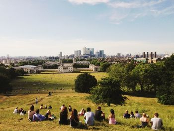 People sitting on grassy field