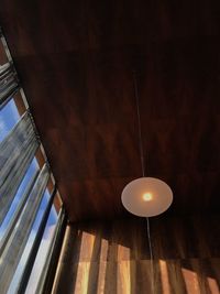 Low angle view of illuminated pendant lights hanging from ceiling