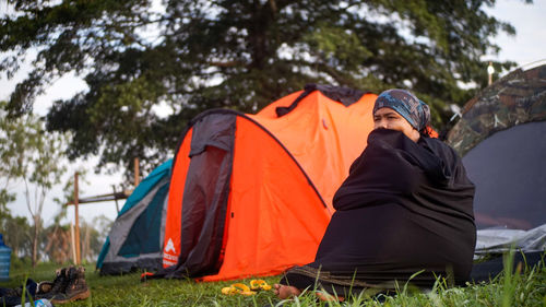 Low angle view of tent on field against trees