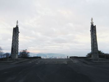 Tower of building against cloudy sky