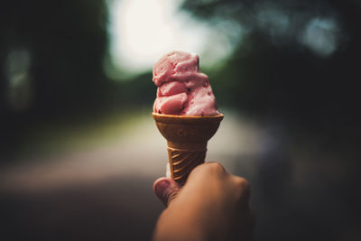 Close-up of person holding ice cream outdoors