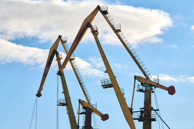 Massive harbor cranes in seaport. heavy load dockside cranes in port, cargo container ship terminal