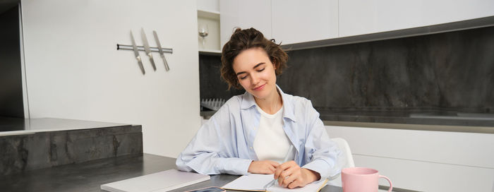 Portrait of young businesswoman working at office