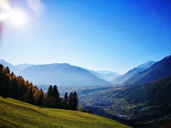 Scenic view of mountains against clear blue sky