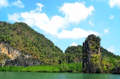 Scenic view of trees and rocks against sky