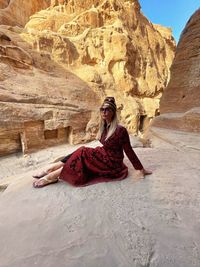 Young woman sitting on rock