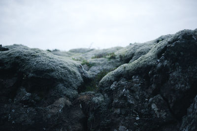 Close-up of rock formation against sky