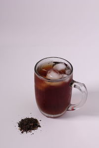 Close-up of coffee cup on table against white background