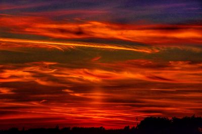 Silhouette landscape against scenic sky