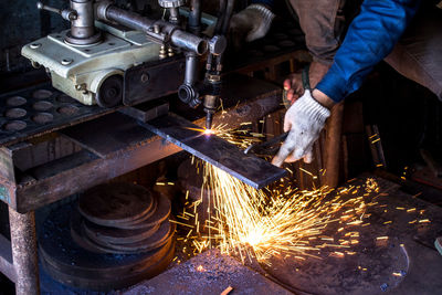 Midsection of man working at workshop