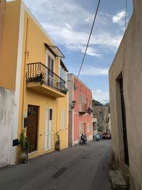 Street amidst buildings against sky in city