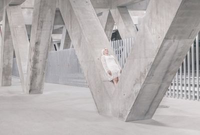 Low angle view of man standing under construction building
