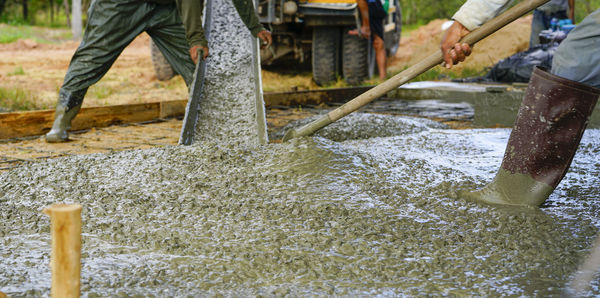 Construction worker pour wet concrete at construction site. construction worker working 