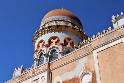 Low angle view of historical building against clear blue sky