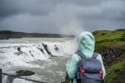 Woman with backpack enjoying golden circle route of iceland
