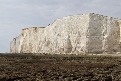 Low angle view of cliff against sky