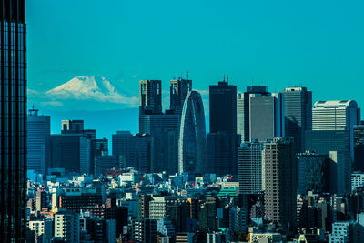 Modern buildings in city against sky