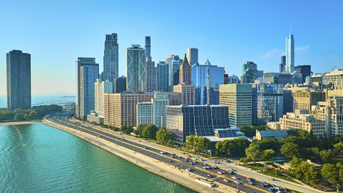 Buildings in city against clear sky