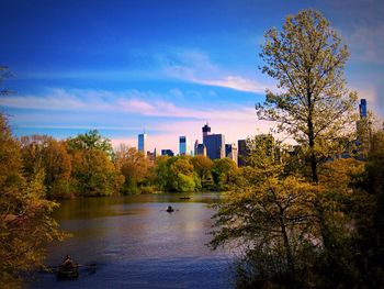 Scenic view of river by trees against sky