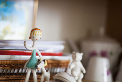 Close-up of figurines on showcase at home